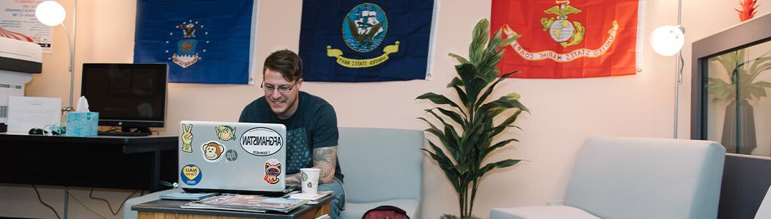 A veteran student works in a veteran services center 